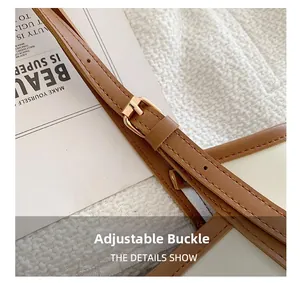 Detail of adjustable shoulder strap with gold buckle and neat stitching on brown tote bag