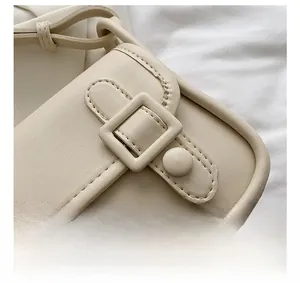Detail shot of beige crossbody bag showing neat stitching and textured PU leather