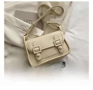 Size comparison of the cream PU leather square crossbody bag with a smartphone