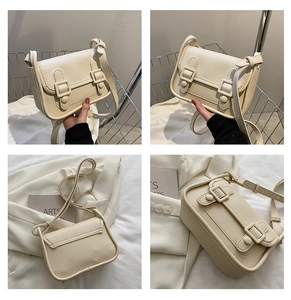 Detail view of cream white PU leather square bag with double buckles and adjustable strap