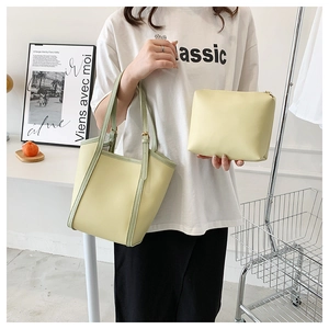 Detailed set of pale green tote and zipper pouch with sleek finish and green edges