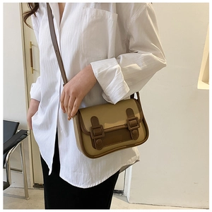 Detail of khaki and caramel vintage crossbody bag with matte PU leather and buckles