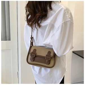 Rear view of a model wearing the vintage khaki and brown crossbody messenger bag