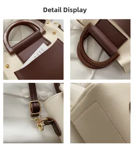 Detail view of contrast color handbag with resin handles and metallic hardware hooks