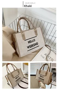 Detail of khaki canvas tote bag featuring Hello Weekend print and leather handles