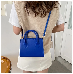 Minimalist Klein blue crossbody bag worn by model showing style and scale