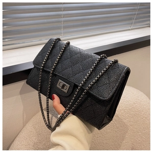 Detail of black caviar leather texture and retro silver twist lock on the shoulder bag