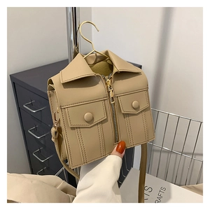 Detail of creative jacket-style mini crossbody bag in khaki with zippers and collar