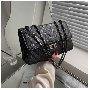 Detailed close-up of caviar texture leather with V-quilted stitching and metal lock