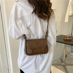 Vintage brown leather crossbody bag with double buckle flap for women in minimal style