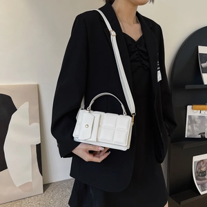 White checkered embossed handbag with adjustable strap and small envelope pocket detail