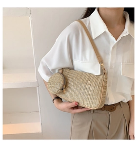 Close-up of a woven straw shoulder bag with a matching round coin purse on a model