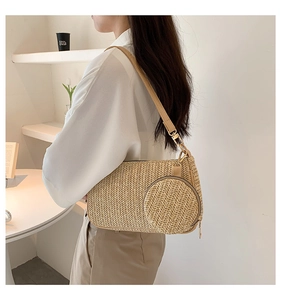 Detail of woven straw shoulder bag with small round coin purse and faux leather strap