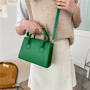 Chic emerald green square handbag with gold hardware and adjustable strap for women