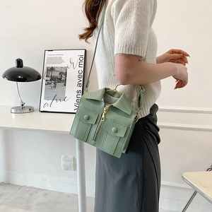 Chic mint green motorcycle jacket-shaped shoulder bag with zipper details and crossbody strap
