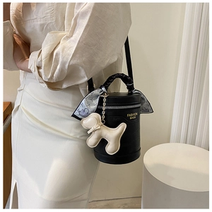 Detailed view of crocodile texture bucket bag with silk scarf and puppy charm