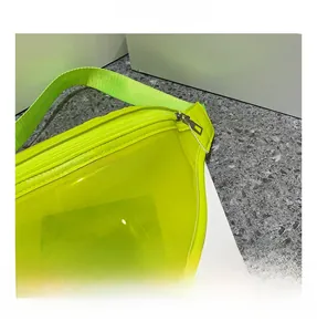 Close-up of neon yellow transparent PVC waist bag featuring Platform text and silver zipper