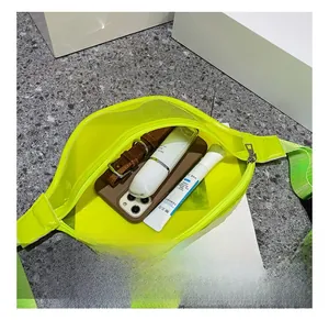 Neon green transparent waist bag showing large capacity with phone and accessories