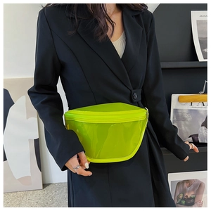 Detailed view of neon green transparent waist bag with zipper on a black suit model