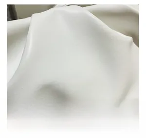 Close-up of soft beige lychee texture leather with natural pleated cloud bag detail
