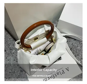 Internal capacity of white pleated cloud bag showing skincare storage space