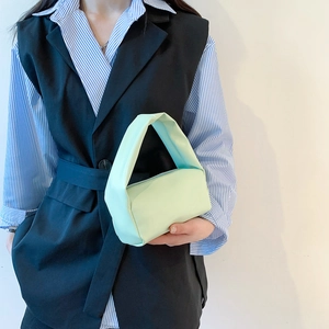 Minimalist mint green faux leather handbag with wide top handle for modern women