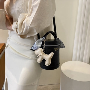 Retro black cylindrical bucket bag with decorative silk scarf and dog charm accessory