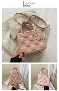 Detailed view of pink cookie-patterned square handbag with PU leather texture