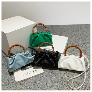 Detailed display of pleated cloud bags with round wooden handles in four stylish colors