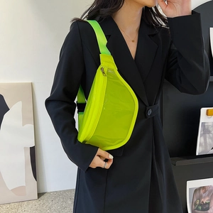 Neon green transparent PVC crossbody fanny pack shown on a model with a black suit