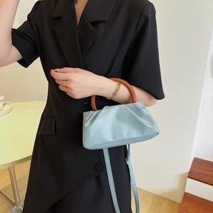 Minimalist light blue pleated cloud bag with stylish brown round handle for women