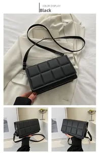 Detail of black quilted leather square bag with adjustable strap and silver metal hardware