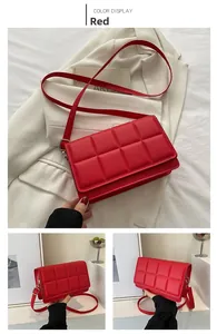 Detail view of red quilted PU leather crossbody bag with adjustable strap and flap closure