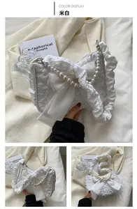 Detailed view of cream textured bubble fabric bag with satin bow and pearl strap