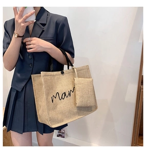 Detailed shot of linen mama tote bag set with matching small zipper pouch and black handles