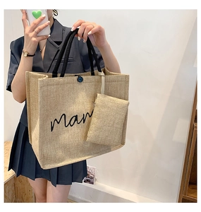 Detail of jute tote bag featuring mama script print and matching small zipper pouch