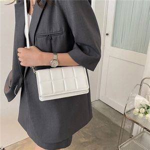 Chic white quilted crossbody flap bag for women featuring a minimalist rectangular design