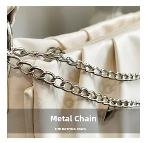 Close-up of the high-quality silver chain strap and pleated leather texture on the bag