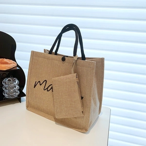Beige jute tote bag with black typography and detachable pouch on white background