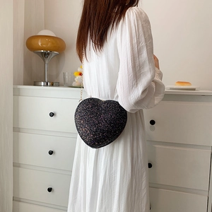 Mini black heart-shaped crossbody bag with glittering sequins and gold chain strap