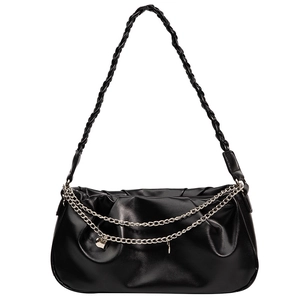 Minimalist black pleated leather underarm bag with silver chains and woven strap