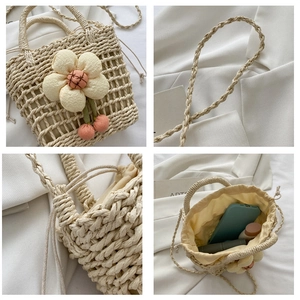Detail view of straw bucket bag with floral decor, drawstring liner and weaving texture