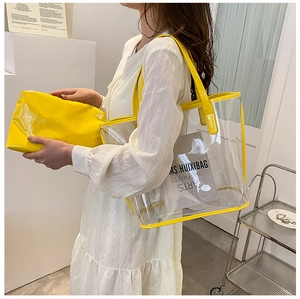 Detail view of transparent PVC tote bag set with yellow inner pouch and trim