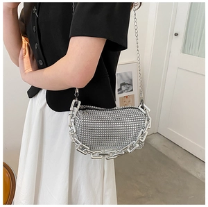 Detail of silver rhinestone square bag with chunky chain handle and crossbody strap