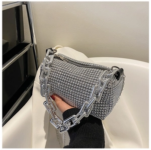 Close-up of sparkling silver rhinestone handbag with chunky metal chain handle detail