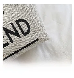 Detail of premium canvas fabric texture with bold black letter printing on beige bag