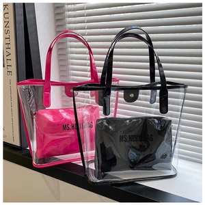 Detail view of large transparent PVC tote bags with matching leather interior pouches