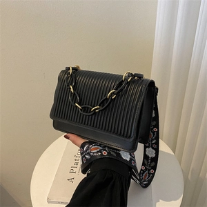 Quilted black crossbody bag with gold chain and floral embroidered wide strap