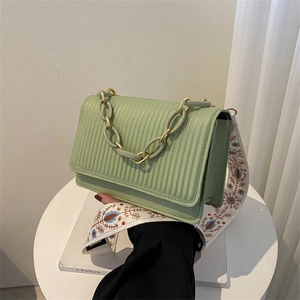 Pale green pleated crossbody bag with golden chain and ethnic embroidered strap
