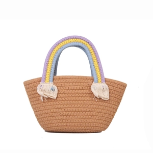 Handmade woven rainbow handle tote bag with white tassel details for beach vacation